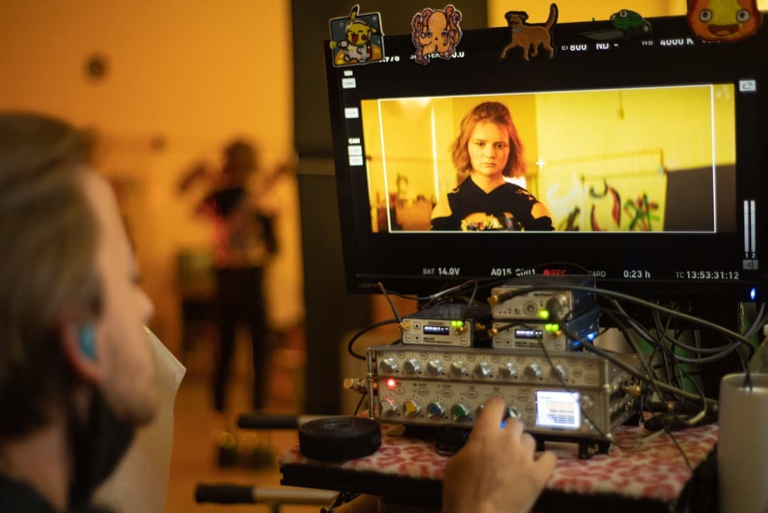 Behind the scenes photo 24 from Clone Cops production showing sound mixer hunter vickers mixing audio on set